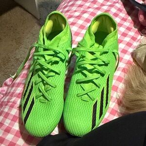 Bright Green Soccer Cleats with Black Stripes